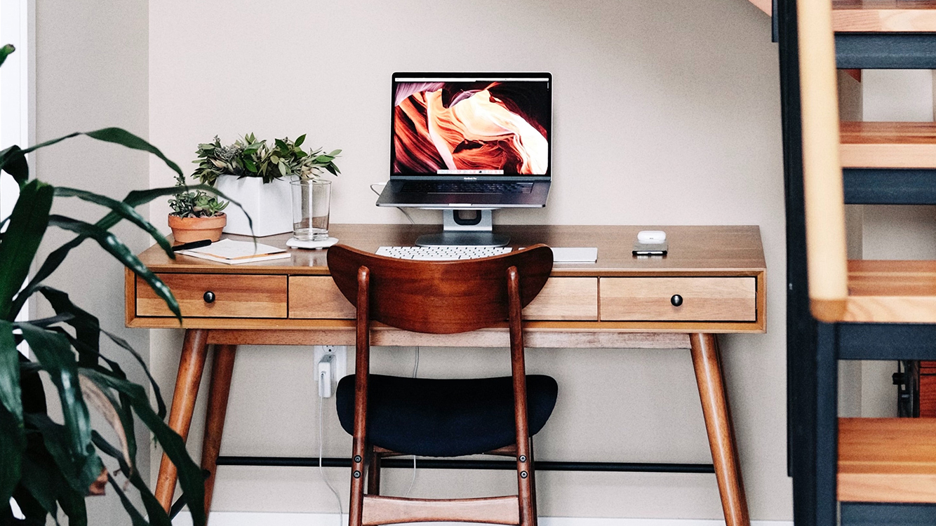 A home office setup featuring a desk, computer, and chair.